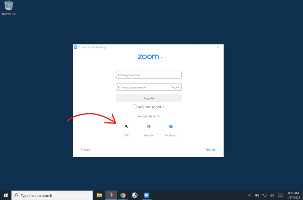screenshot of a PC desktop with arrow pointing to the Zoom SSO login button